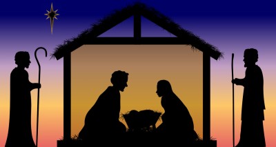Silhouette of nativity scene with Mary and Joseph kneeling next to Jesus in manger and shepherds standing outside the stable 
